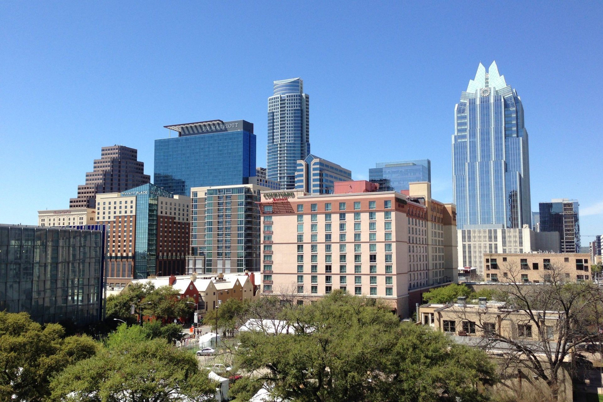 A city skyline with a hotel in the foreground